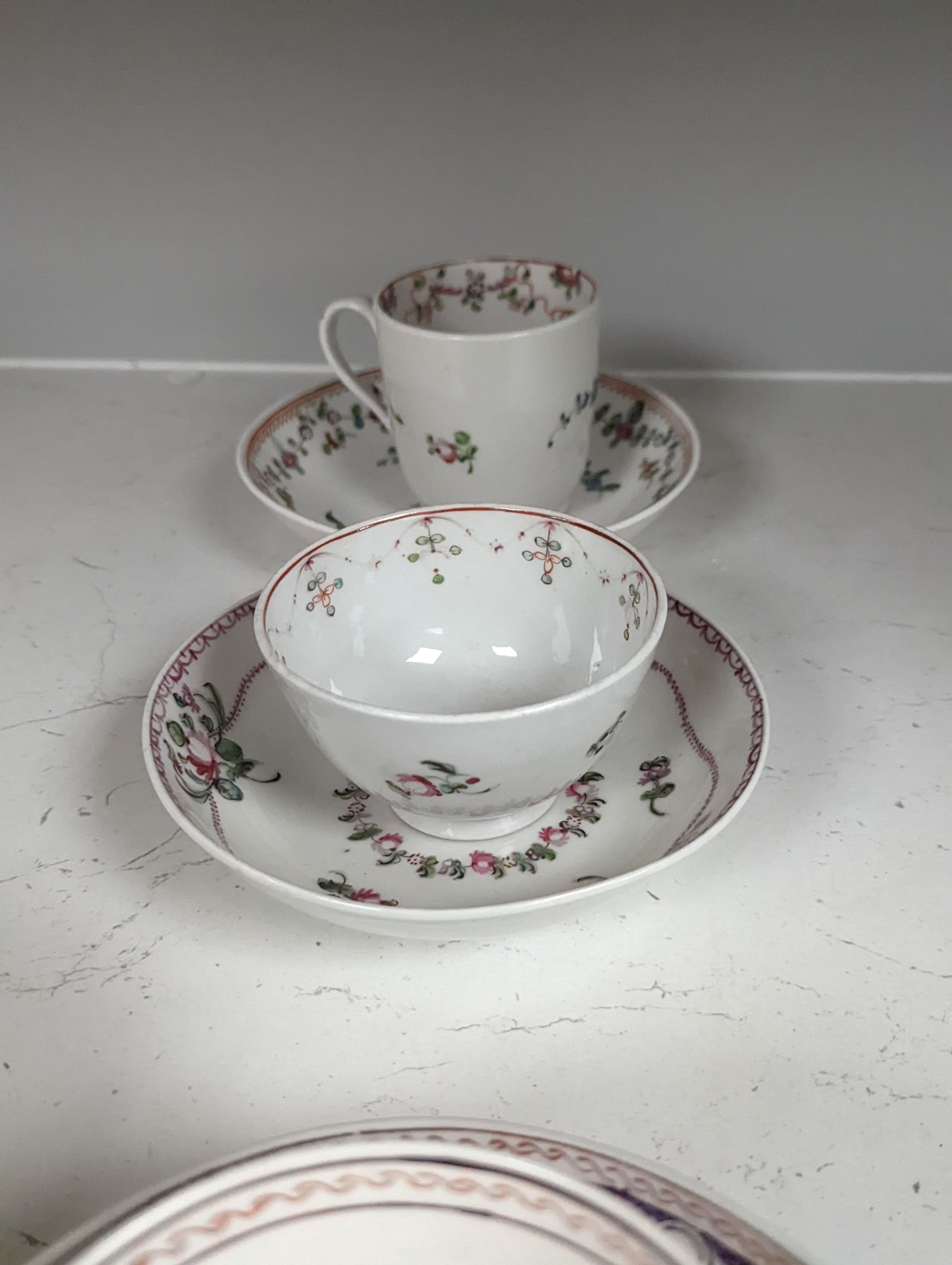 New Hall style study collection: a cream jug pattern 524, a teabowl and saucer with oriental figures, and another teabowl and saucer, a shankered teacup and saucer, two coffee cups, three teabowls, four saucers and a slo